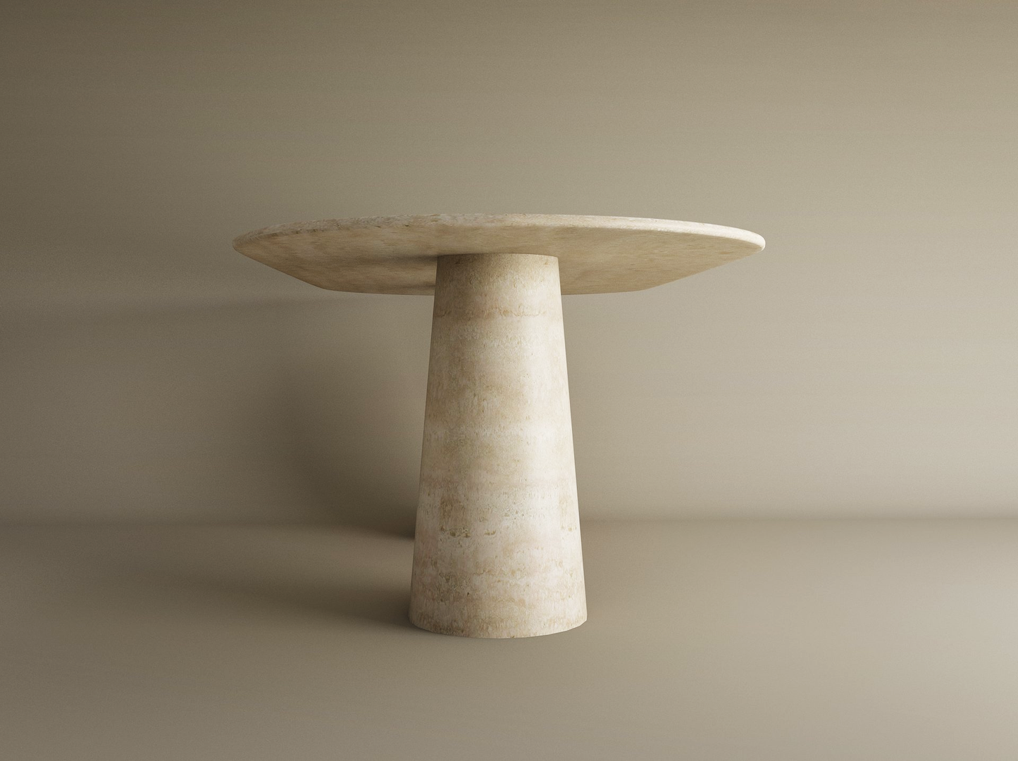 The TRAVERTABLE Oval Travertine Dining Table features an organic travertine stone conical pedestal base and a spacious natural tabletop, shown here against a plain beige background.