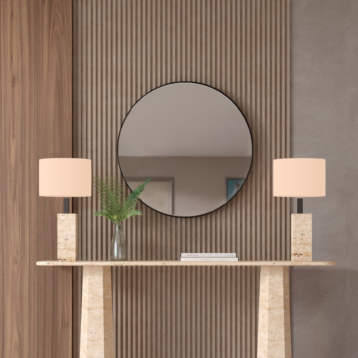 A TRAVERTABLE Rectangular Travertine Console Table with Tapered Round Base displays two lamps with rectangular bases, beige shades, and a vase with greenery. A round mirror on a ribbed wood accent wall adds contemporary flair behind the table.