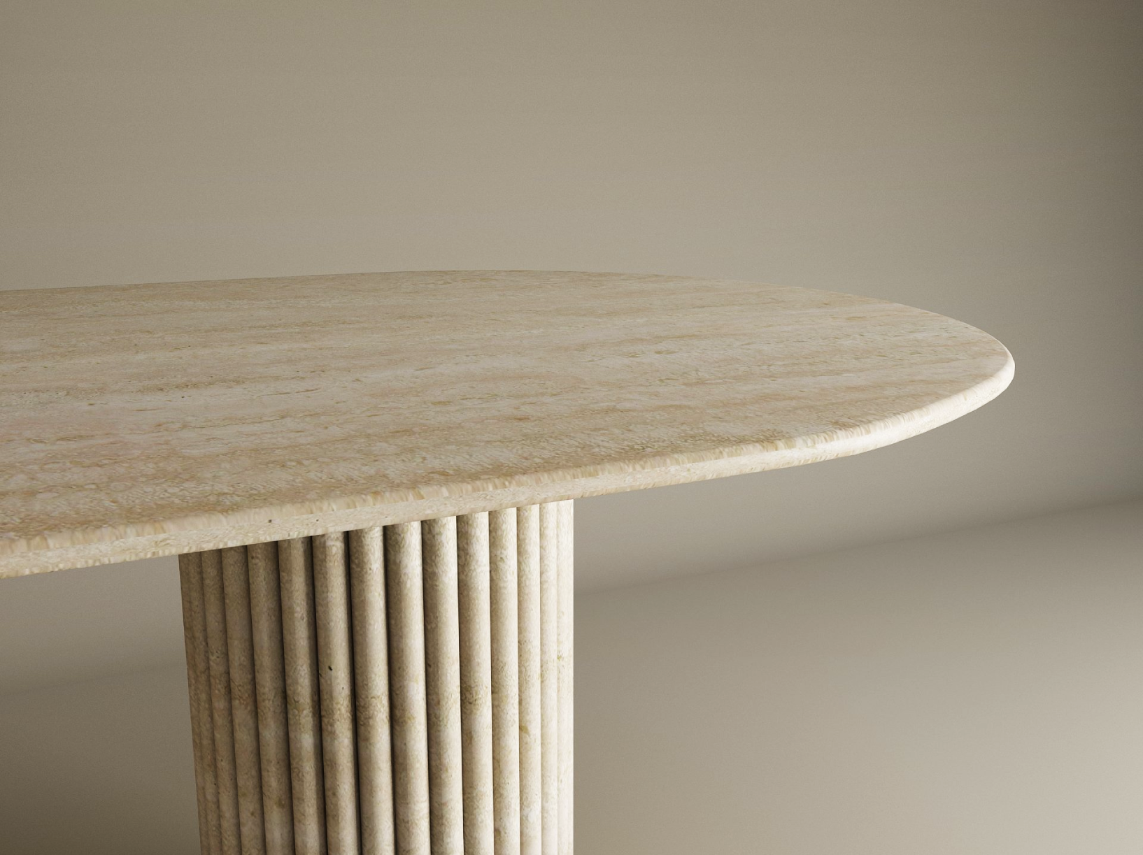 A close-up of the TRAVERTABLE Oval Travertine Dining Table shows its beige natural stone top, rounded edge, and fluted vertical groove base—an elegant, customizable piece set against a light background.