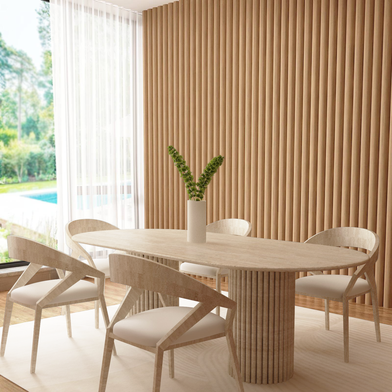 A modern dining room features the TRAVERTABLE Oval Travertine Dining Table with Vertical Groove Base, matching chairs, a white vase with green stems, beige floor rug, and vertical wooden paneling. Large windows showcase lush greenery and a pool.