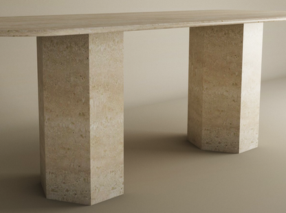 The TRAVERTABLE Rectangular Travertine Dining Table features a natural stone tabletop and two hexagonal pedestal bases, blending minimalist design with organic travertine—perfect for modern dining spaces. Customizable to fit your style.