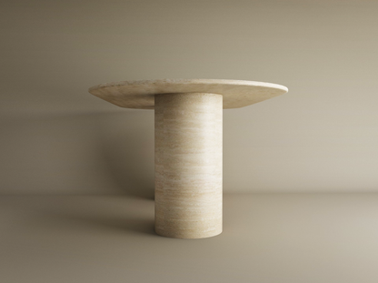 The TRAVERTABLE Oval Travertine Dining Table features a pure travertine stone base in a smooth cylinder shape and a wide oval top, shown in beige against a matching background. Customizable to fit your dining space.