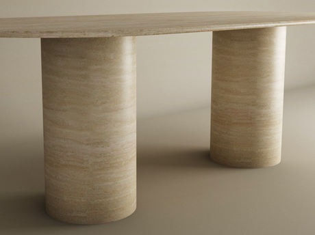 The TRAVERTABLE Oval Travertine Dining Table features a smooth cylinder pure travertine stone base and an elegant natural stone tabletop, customizable to suit your space, shown here in beige against a neutral background.