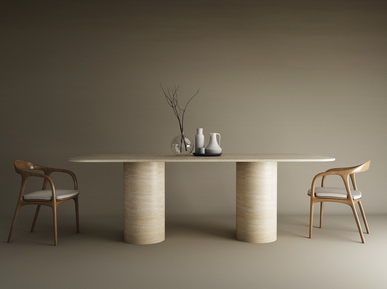 The TRAVERTABLE Rectangular Travertine Dining Table with Cylindrical Base sits between two wooden chairs with white cushions. On the natural stone surface are a clear vase with branches and three ceramic vessels, set against a plain brown wall.