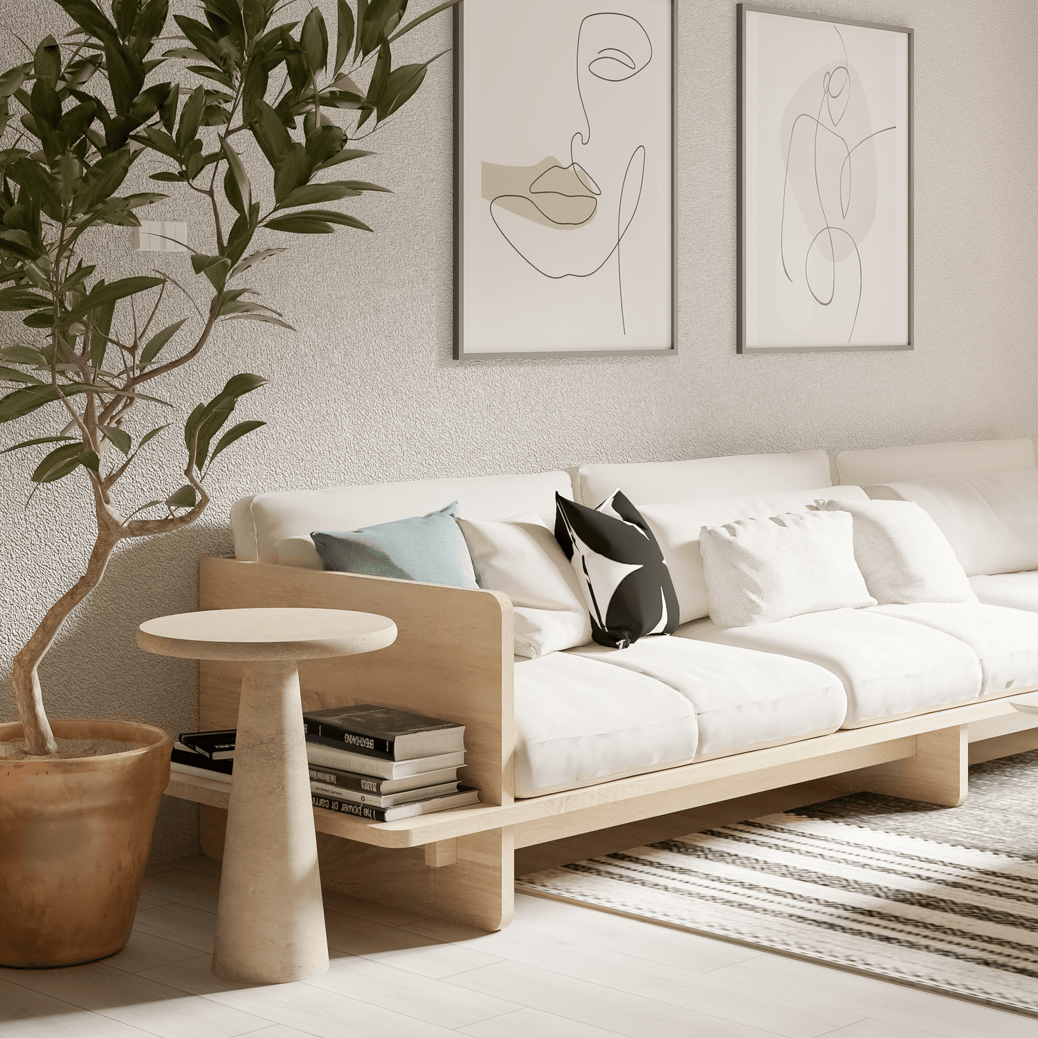 A modern living room features a cream-colored sofa with black and white pillows on a striped rug. Abstract art decorates the wall above, while a large potted plant stands nearby. The centerpiece is the Tavolino Pietra Travertine Column Table by Travertable, holding books next to the sofa.