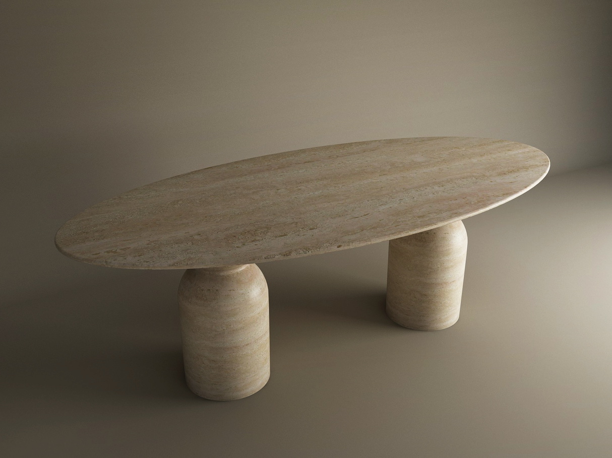 The Ellips Travertine Dining Table by TRAVERTABLE features a customizable natural travertine stone top with a sculptural round organic base, all in a matching beige marbled finish, set against a neutral background.