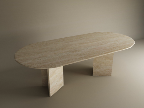 The TRAVERTABLE Oval Travertine Dining Table features a smooth, natural stone top and a split-V pedestal base, standing elegantly in a minimally lit, neutral-toned room. Customizable design with premium travertine stone.