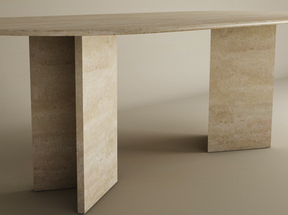 The TRAVERTABLE Oval Travertine Dining Table features a travertine stone base with a split-V pedestal and customizable design—an elegant, polished heirloom piece that elevates any space.