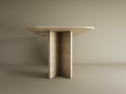 The TRAVERTABLE Rectangular Travertine Dining Table features a natural travertine stone top and a split-V pedestal base—a customizable, minimalist heirloom piece perfect for modern spaces.