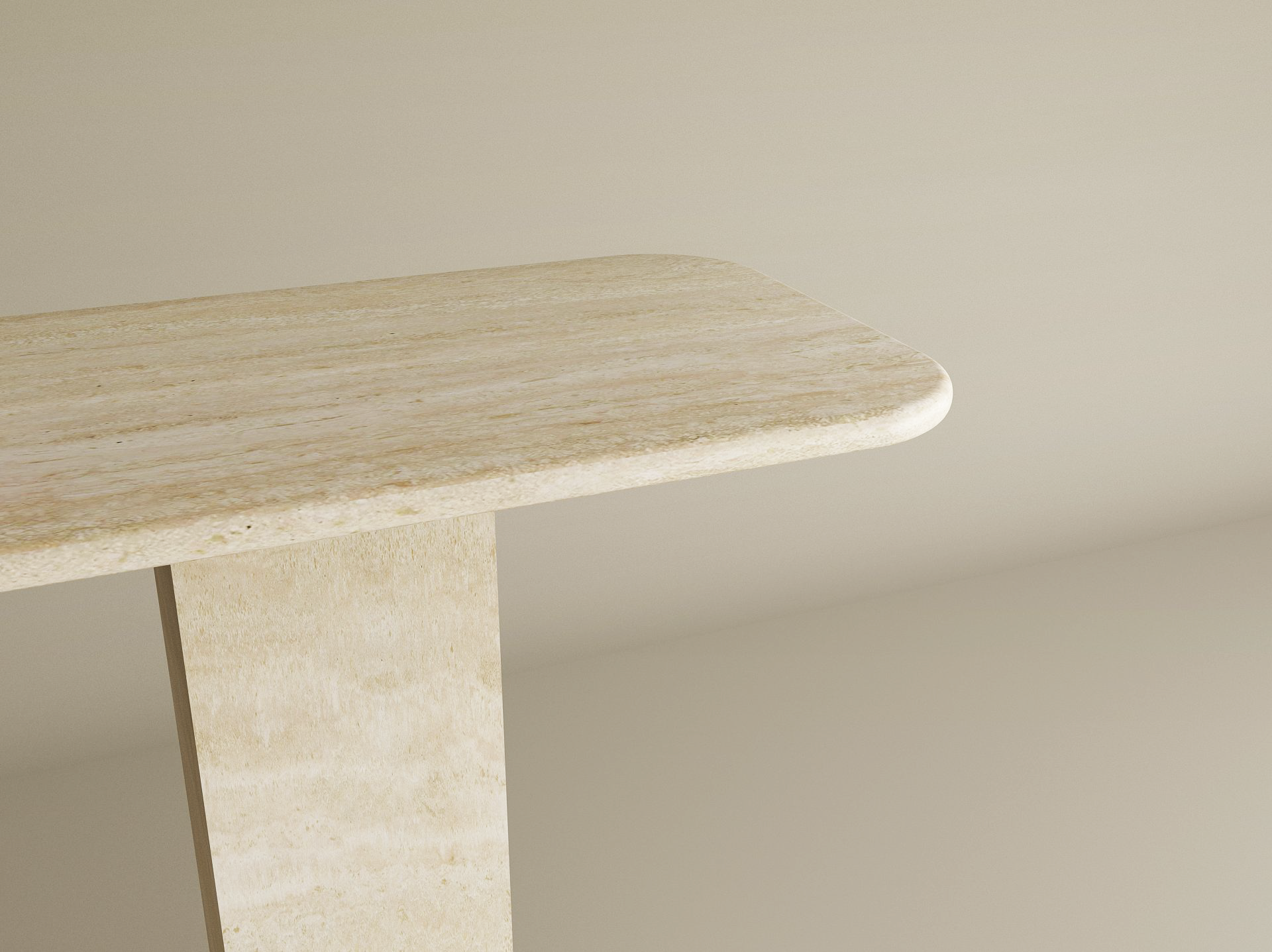 A close-up of the TRAVERTABLE Rectangular Travertine Console Table shows its light beige travertine stone top with rounded edge and rectangular pedestal base, set against a plain matching background.