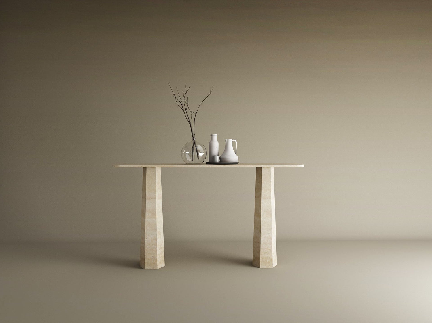 The TRAVERTABLE Rectangular Travertine Console Table with a solid, tapered round base displays a glass vase and ceramic vessels in minimalist beige, set against a plain background. This customizable piece offers contemporary elegance.