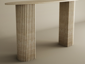 The Ellips Travertine Console Table by TRAVERTABLE features a smooth beige top and fluted round solid travertine stone base, exuding refined luxury and customizable elegance in any neutral space.