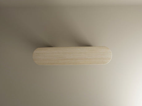 A rectangular wooden shelf with rounded corners is mounted on a beige wall, its soft shadows echoing the sculptural elegance of TRAVERTABLE’s Ovale Travertine Console Table with Vertical Groove Base—an organic stone centerpiece.