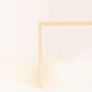 Detailed view of the customizable travertine coffee table's edge and finish options