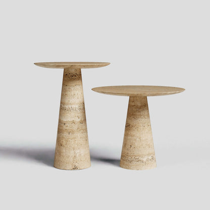 The Twin Pillars Travertine Side Table Set by Travertable exudes natural elegance against a gray backdrop, showcasing round tops with conical bases in beige and brown marble; one table is gracefully taller than the other.