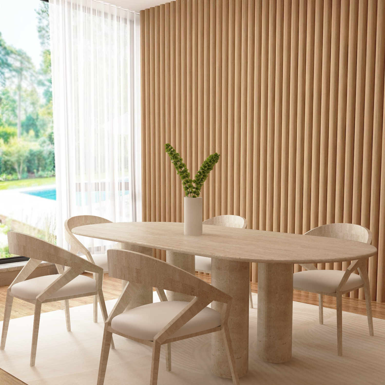 A modern dining area features TRAVERTABLEs Oval Travertine Dining Table with Cylindrical Base, four chairs with white cushions, a tall vase of greenery as centerpiece, vertical wood paneling, and large windows displaying lush outdoor views.