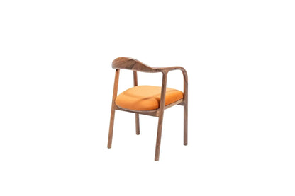 The Travertable Contemporary Curve Armchair features a wooden frame with a curved backrest and four slender legs. Its vibrant orange fabric seat contrasts against a plain white background, embodying modern design.