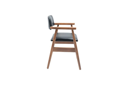 A side view of the Travertable Executive Elegance Armchair showcases wooden legs and ergonomic armrests. The seat and backrest are upholstered in dark faux leather, featuring a minimalist design with clean lines against a white background.