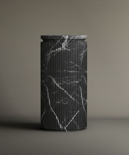 The TRAVERTABLE Nero Marquina Round Marble Pedestal Vanity Sink, featuring vertical grooves and white veining, stands upright with a matching flat lid on a neutral background—ideal for stylish bathroom design.