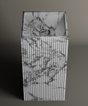The TRAVERTABLE Calacatta Square Fluted Marble Pedestal Vanity Sink features gray-veined marble and vertical fluting, ideal for elevating any modern bathroom against a plain background.