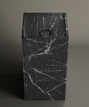 The TRAVERTABLE Nero Marquina Square Fluted Marble Pedestal Vanity Sink features a rectangular basin with white veining, vertical fluted sides, and a centered drain, set against a plain neutral background.