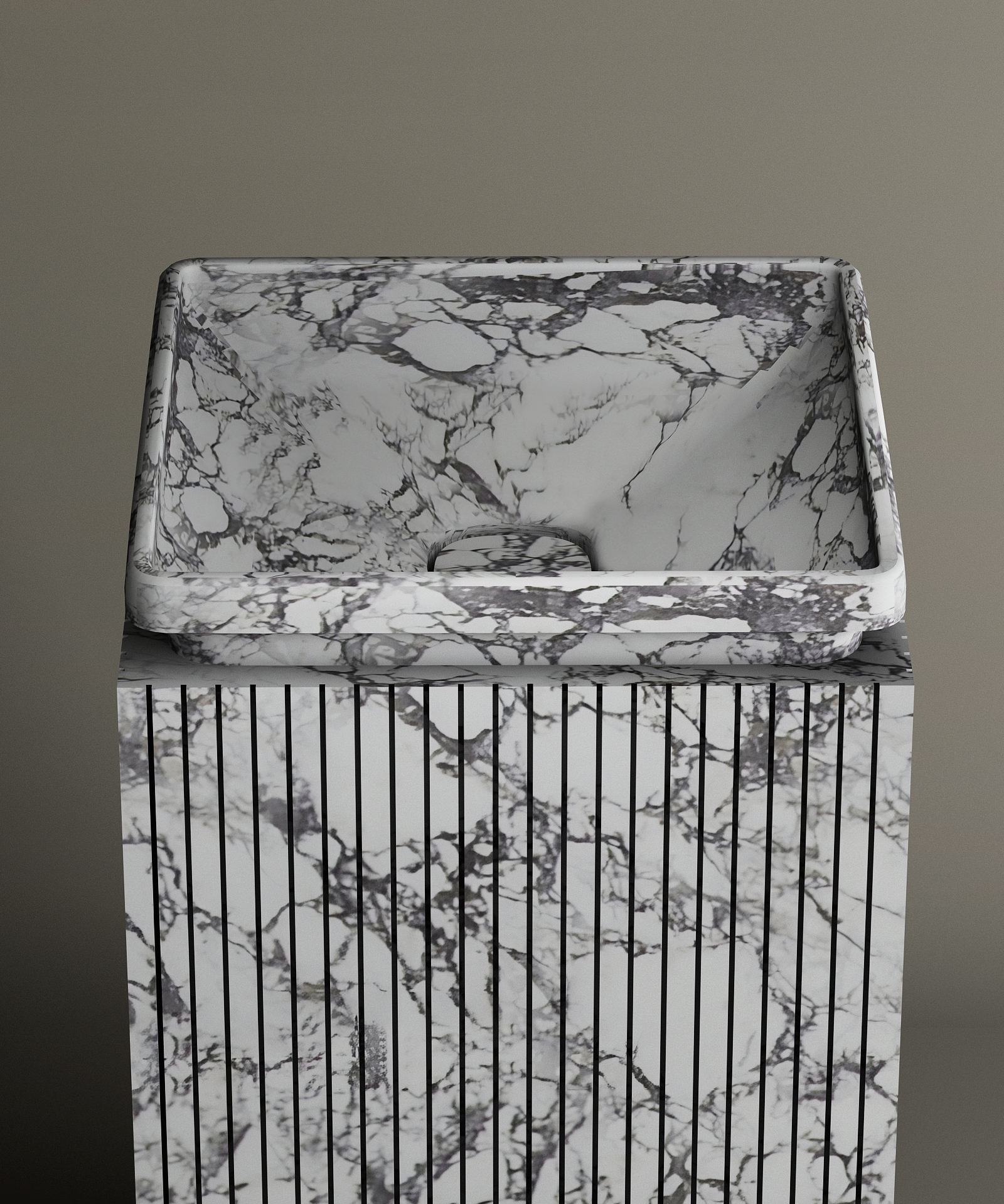 The TRAVERTABLE Calacatta Square Marble Pedestal Vanity Sink, with gray and black veining and vertical grooves, creates a bold marble centerpiece against a plain gray background.