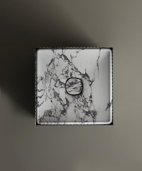 The TRAVERTABLE Calacatta Square Fluted Marble Pedestal Vanity Sink features a white marble design with bold dark veining, matching drain cover, and straight edges, shown from above on a matte surface.