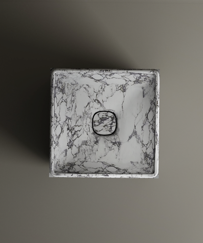 The TRAVERTABLE Calacatta Square Marble Pedestal Vanity Sink, with elegant gray veining and a central square drain, is displayed from above on a matte gray background—an ideal choice for modern bathroom designs.